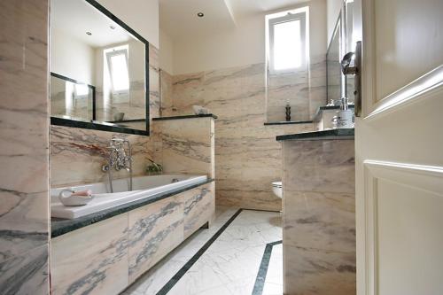 a bathroom with a tub and a sink and a mirror at Kwatera Prywatna Maja in Sopot