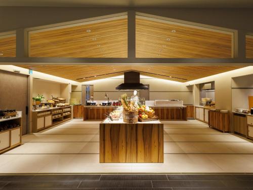 a large kitchen with a table with food on it at Asakusa View Hotel Annex Rokku in Tokyo
