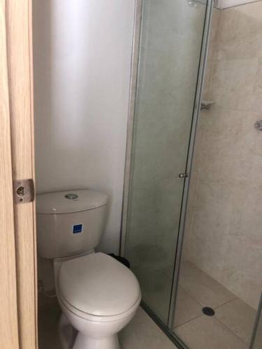 a bathroom with a toilet and a glass shower at Apartamento familiar in Sincelejo