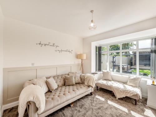 a living room with a couch and a window at Vallum Villa - Uk40231 in Bardon Mill