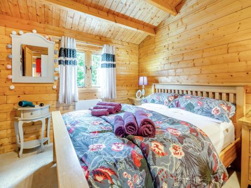 a bedroom with a bed in a wooden cabin at The Cabin Cefn Mawr in Highgate