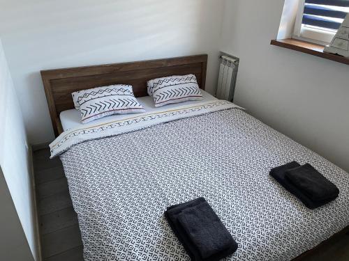 a bed with two pillows on top of it at Apartament przy Parku in Żywiec