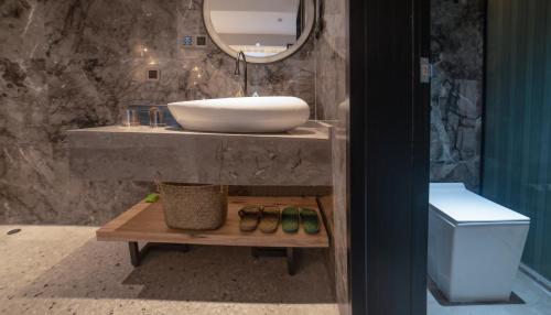 a bathroom with a sink and a mirror at 张家界惹莲心栖墅·精品民宿 in Zhangjiajie