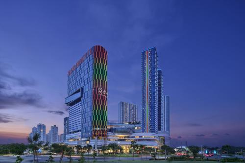 a rendering of a tall building in a city at Four Points by Sheraton Surabaya, Pakuwon Indah in Surabaya