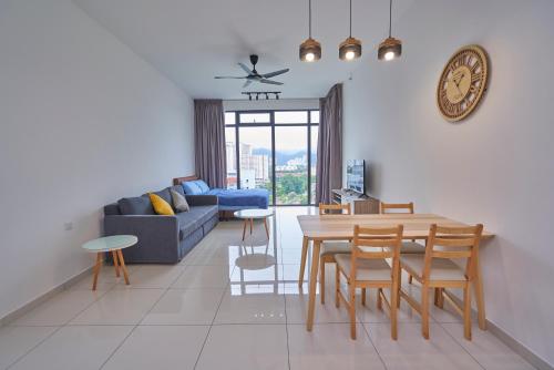 a living room with a table and a blue couch at Beacon2BR #InfinityPool #Georgetown #FamilyHoliday in George Town