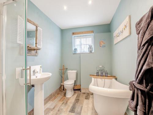 a bathroom with a sink and a toilet and a shower at The Old Stables in Cumberworth