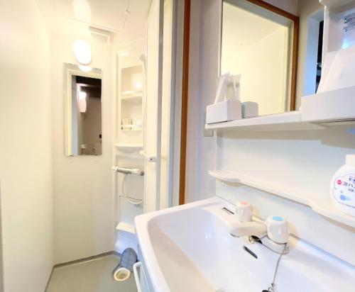 a white bathroom with a sink and a mirror at One Night, One View, Lifelong Marriage, Yotsukaido - Vacation STAY 12735 in Yotsukaidō