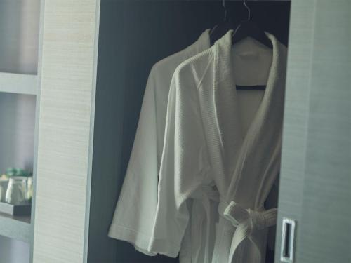 a closet with a white shirt hanging on a door at The Park Front Hotel at Universal Studios Japan in Osaka