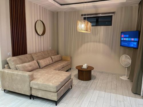 a living room with a couch and a tv at Luxe appartementen Paramaribo Noord in Paramaribo