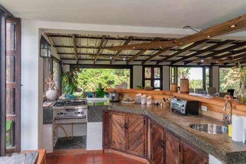 a kitchen with wooden cabinets and a stove top oven at La Maima in Dapa