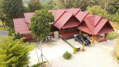 an aerial view of a house with red roofs at Khunkhao Maenamchan Homestay ขุนเขา แม่น้ำจัน โฮมสเตย์ in Chiang Rai