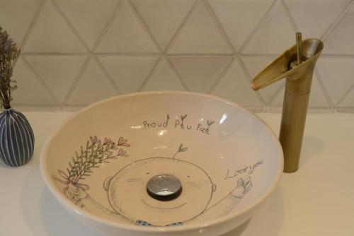 a bowl with a drawing of a teddy bear on it at Proud Phu Fah Muang Chiang Mai in Chiang Mai
