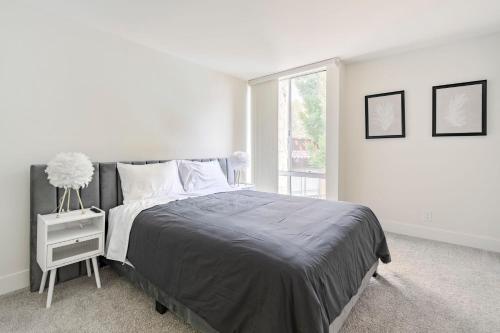 a white bedroom with a bed and a window at New Luxury Apartment WeHo Boys Town in Los Angeles
