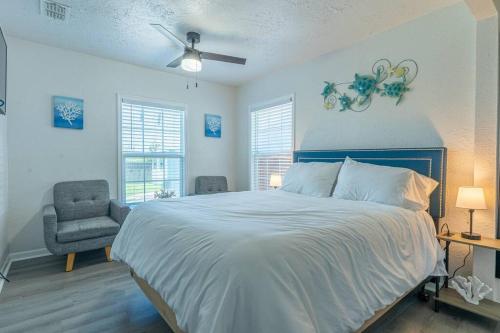 a bedroom with a large bed and a chair at Blue Oasis minutes from the beach with Gameroom! in Corpus Christi