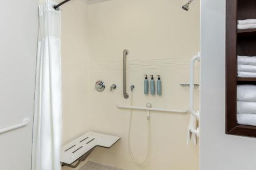 a white bathroom with a shower and a sink at Residence Inn by Marriott Corona Riverside in Corona