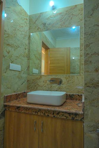 un baño con lavabo y espejo en HOTEL VIEW, en Govardhan