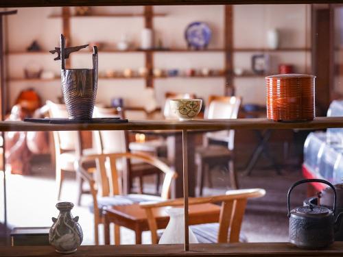 a table in a room with chairs and a table with a vase at Sasai Hotel in Otofuke