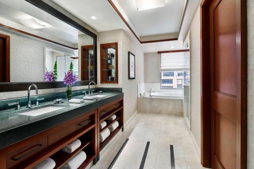 a bathroom with two sinks and a large mirror at The Ritz-Carlton Georgetown, Washington, D.C. in Washington