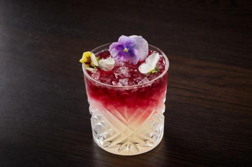 a glass with a purple drink with a purple flower in it at The Ritz-Carlton Georgetown, Washington, D.C. in Washington