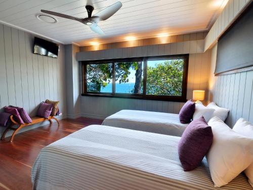 sypialnia z 2 łóżkami i oknem w obiekcie Dolphins at Sunset w mieście Amity Point