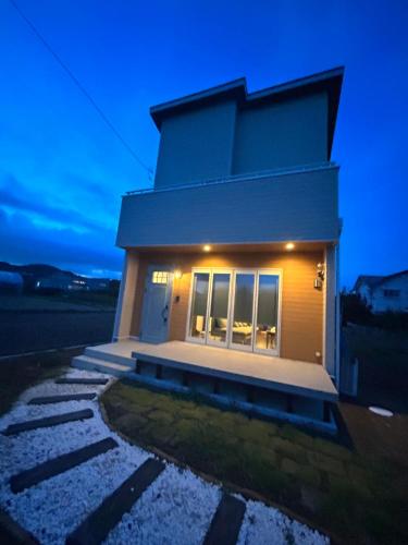 a small house with lights on the side of it at South coast Chikura in Chikura