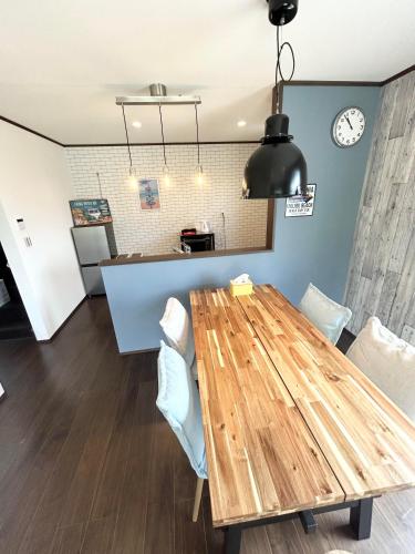 a dining room with a wooden table and chairs at South coast Chikura in Chikura