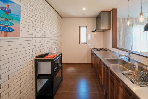 a kitchen with a sink and a counter at South coast Chikura in Chikura
