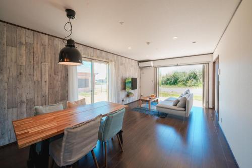 a dining room with a wooden table and chairs at South coast Chikura in Chikura