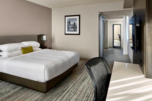 a hotel room with a bed and a table at Marriott Hartford/Windsor Airport in Windsor