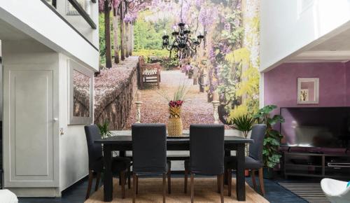 a dining room with a table and chairs with a wall mural at Margutta 46 private spa in Rome
