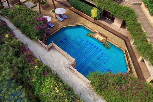 an overhead view of a swimming pool with flowers at Hyderabad Marriott Hotel & Convention Centre in Hyderabad