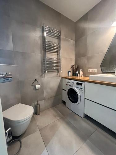 ein Badezimmer mit einem WC, einem Waschbecken und einer Waschmaschine in der Unterkunft Axis Towers 1 bedroom 4 guests! in Tbilisi City