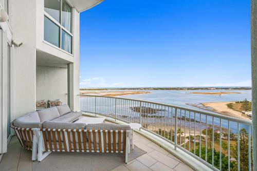 a balcony with a couch and a view of the ocean at Crystal Bay On The Broadwater in Gold Coast