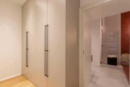 a room with white walls and sliding doors at Luxurious Minimalist Residence with Sauna by Prestige Homes in Budapest