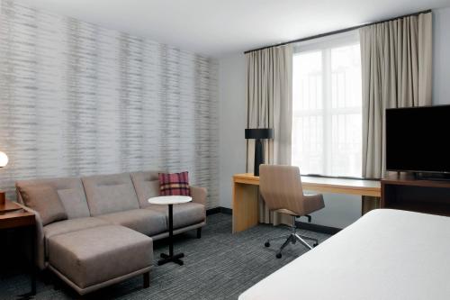 a hotel room with a couch and a desk at Residence Inn by Marriott Norwalk in Norwalk