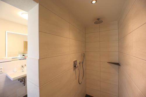 a bathroom with a shower and a sink at Maurerlehen in Berchtesgaden