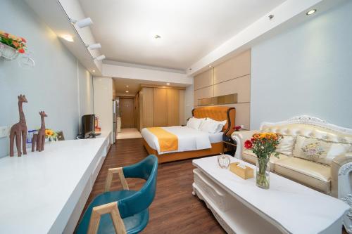 a hotel room with a bedroom with a bed and a couch at Orange International Hotel Guangzhou Zhujiang New Town US Consulate General Guangzhou Branch - Free Shuttle Bus to Canton Fair Complex During Canton Fair Period in Guangzhou