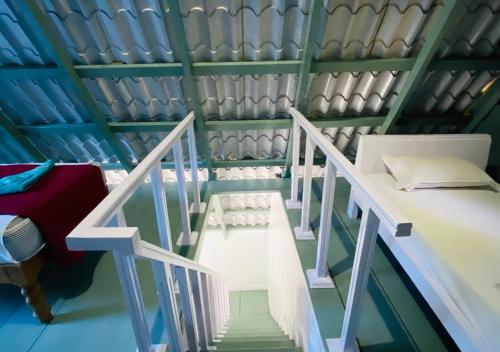 a room with a staircase leading to a bunk bed at Falling Water Resort by Travent Mug in Sakleshpur