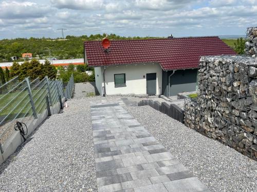 a house with a red roof and a stone wall at Stilapartment Loft in Wernigerode