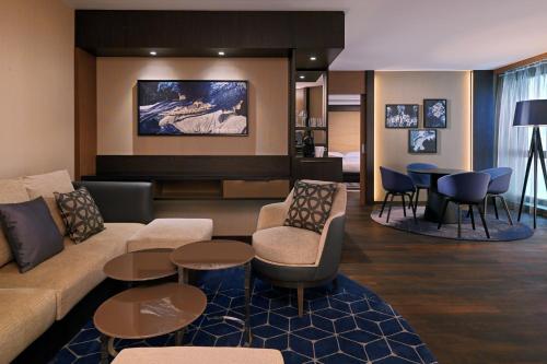 a living room with a couch and chairs and tables at Sheraton Grand Tbilisi Metechi Palace in Tbilisi City
