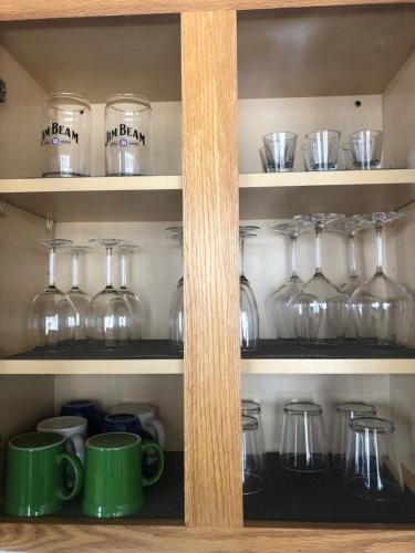 a pantry with glasses and cups on shelves at Winter Wonderland Retreat and Your Chicago Chill Getaway in Chicago