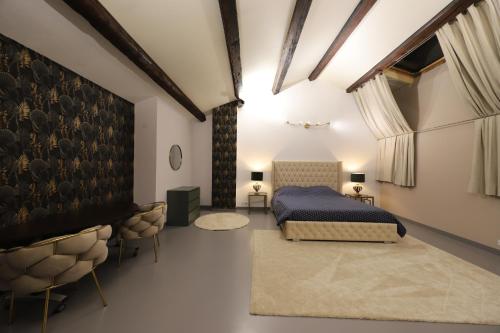 a bedroom with a king sized bed and a table at Loft 250m2 avec écran led géant de 10m2 in Marseille