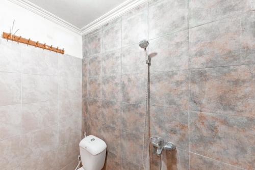 a bathroom with a shower with a toilet in it at RedDoorz Syariah At Cibadak Sukabumi in Sukabumi