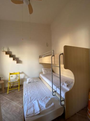 a room with two bunk beds and a staircase at Villa Armonia in Skala Potamias