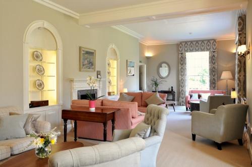a living room with a couch and chairs and a table at Congham Hall Hotel & Spa in Grimston
