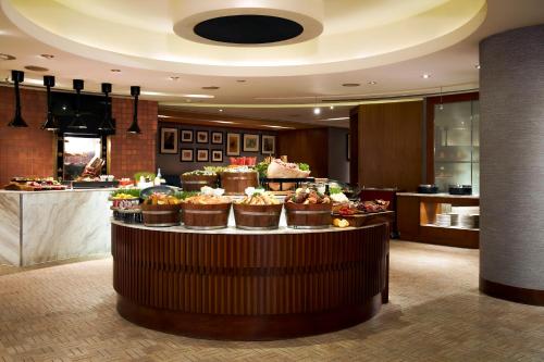 a display of cupcakes on a table in a hotel lobby at Conrad Bangkok in Bangkok