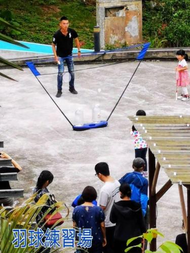 a man is standing on the ice with a rope at Green Shine B&B in Nanzhuang