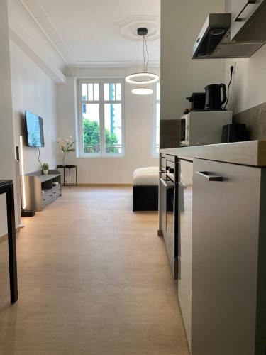 a room with a kitchen and a living room at 101 Beffroi in Thionville