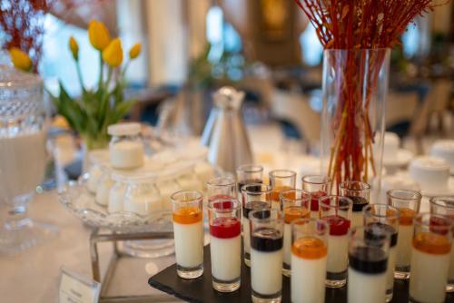 a table with a bunch of wine glasses and a vase at Northern Charm Hotel in Ho Chi Minh City