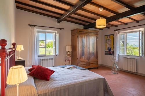 a bedroom with a bed and two windows at Villa Gabry in Gambassi Terme